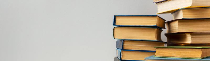 A collection of linguistics textbooks arranged on a table, symbolising the study of language and communication.