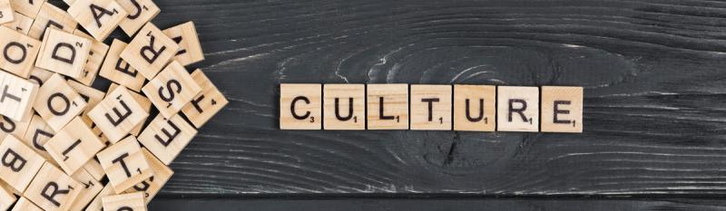 Wooden blocks spell "culture" against a black background, emphasising the theme of cultural identity and expression.