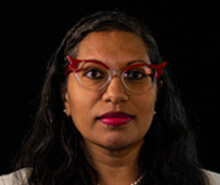 Flat icon of a woman with long hair, holding a folder, looking at the camera.